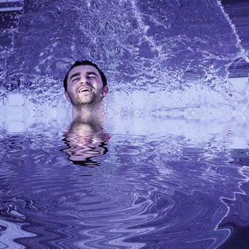 young attractive man relax in spa area