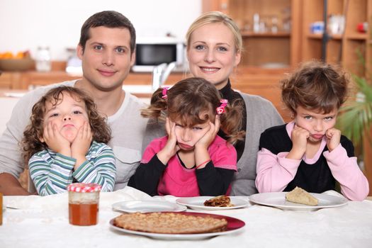 Sulky children with pancakes