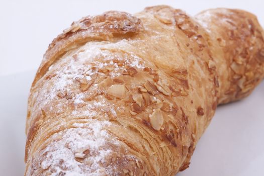 fresh almond croissant isolated on a white  background