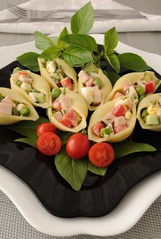 Large pasta shells stuffed with vegetables and ham