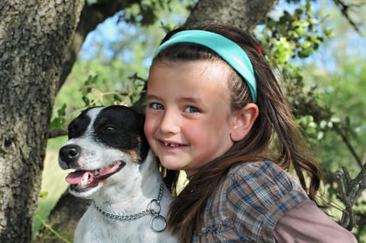 smiling little girl and her jack russel terrrier