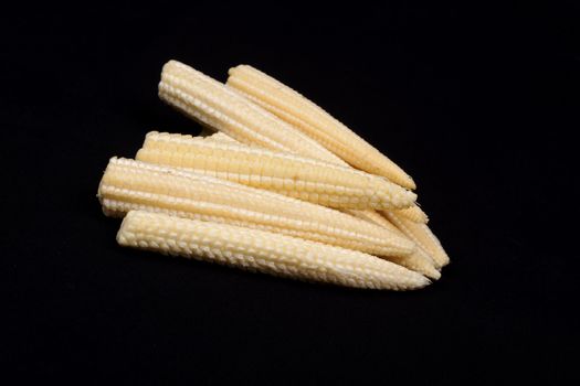 Baby corn  isolated on black background