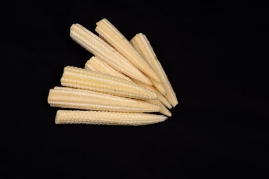 Baby corn  isolated on black background