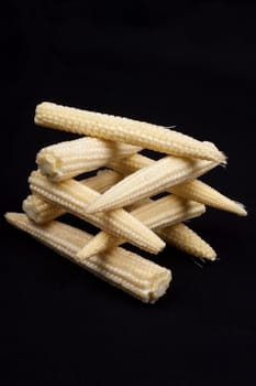 Baby corn  isolated on black background