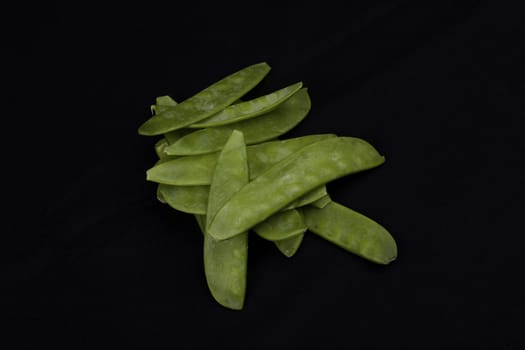 Mangetout Peas isolated on black background