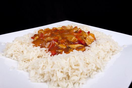 Closeup photo of chinese sweet and sour chicken with rice.