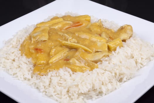 diced chicken in coconut curry sauce served with rice