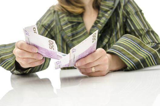 Business woman counting Euro banknotes on a white desk.