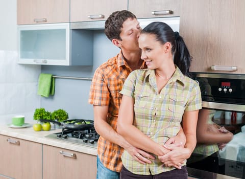 Portrait of a young couple at kitchen