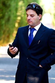 View of a young male business man on a asphalt road.