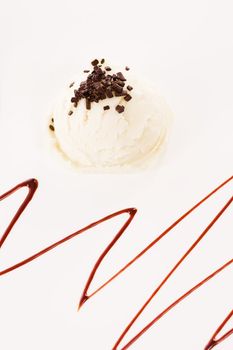 vanilla flavor ice cream with chocolate crumbles from top with chocolate sauce garnish