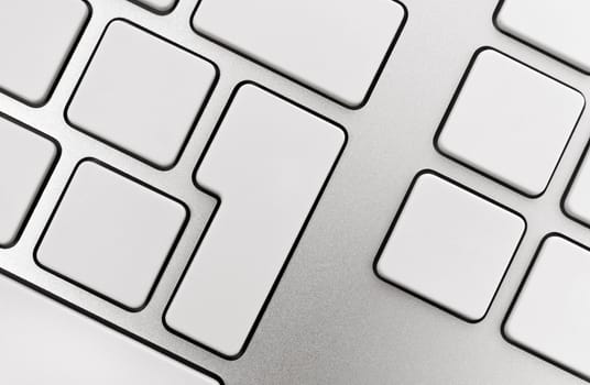 Blank buttons on modern aluminum keyboard.