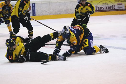 ZELL AM SEE; AUSTRIA - SEPT 24: Austrian National League. A player of Lustenau (yellow jersey) falls over a player of EKZ. Game EK Zell am See vs EHC Lustenau (Result 1-8) on September 24, 2011 in Zell am See.