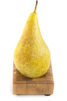 A picture of a pear sitting on a wooden stand