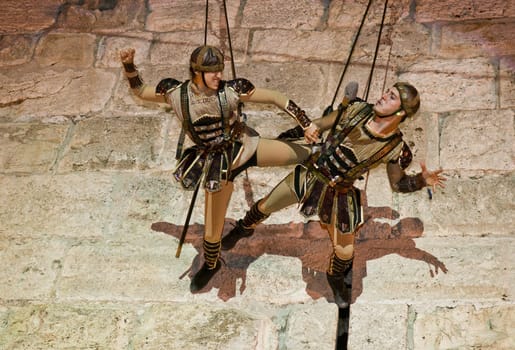 JERUSALEM - NOV 03 : An Israeli acrobats dressed as knight climbing on the old city walls in the annual medieval style knight festival held in the old city of Jerusalem on November 03 2011