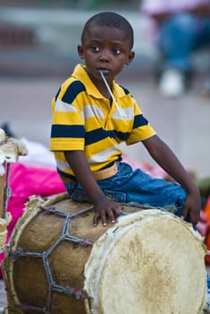 CARTAGENA , COLOMBIA - DEC 22 : Local child sitting on a drum while preparation for the celebration , held in the Unesco world heritage city of Cartagena , Colombia on December 22 2010