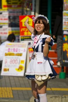 KYOTO , JAPAN - OCT 29 : Japanese girl dressed as a maid promoting "Maid cafe" in Tokyo Japan on October 29 2009 , In Maid cafes the waitresses dressed in maid costumes and act as servants , these cafes are very popular in Japan 