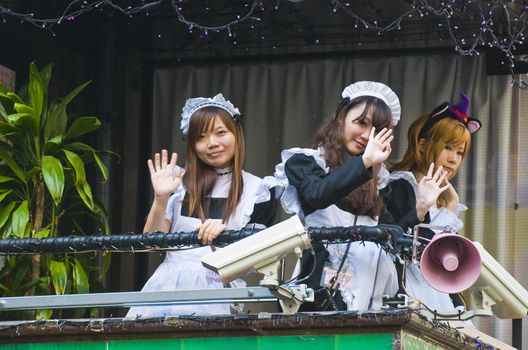 KYOTO , JAPAN - OCT 29 : Japanese girls dressed as a maid promoting "Maid cafe" in Tokyo Japan on October 29 2009 , In Maid cafes the waitresses dressed in maid costumes and act as servants , these cafes are very popular in Japan 