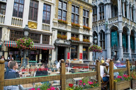 BRUSSELS - JULY 2 : Unidentified people seat in a cafe at Grand place Brussels , Belgium on July 2 2011 , Grand place is "Unesco world heritage" site since 1998.  