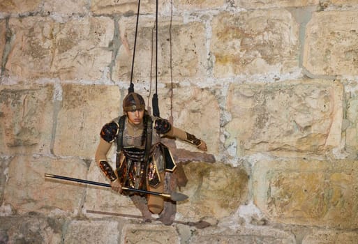 JERUSALEM - NOV 03 : An Israeli acrobat dressed as knight climbing on the old city walls in the annual medieval style knight festival held in the old city of Jerusalem on November 03 2011