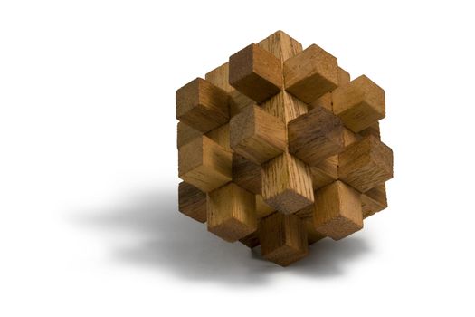studio photography of a wooden 3D-puzzle in white back