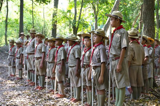 MUAKLEK, SARABURI - FEB 29: A troop of Boy Scouts marches in a Camp Parade on Feb 29, 2012 with The forest in the background in MUAKLEK, SARABURI THAILAND