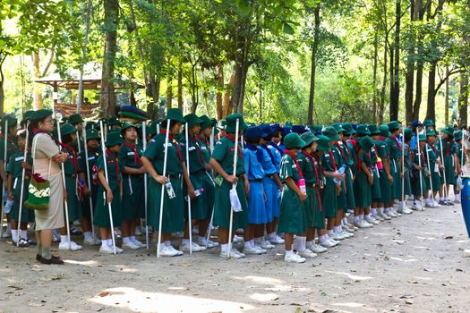 MUAKLEK, SARABURI - FEB 29: A troop of girl Scouts marches in a Camp Parade on Feb 29, 2012 with The forest in the background in MUAKLEK, SARABURI THAILAND