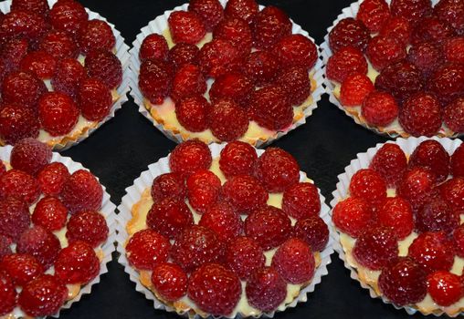 Tarts filled with raspberries and custard