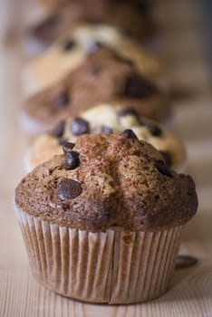 delicious homemade muffins over wooden board selective focus