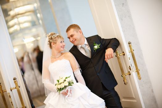 bride and groom at the opened doors