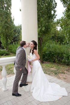 bride and groom near the column