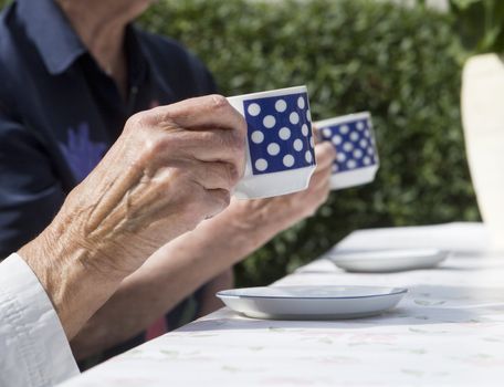 Unreconizable Older women drinking coffee