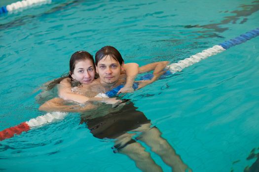 portrait of a couple in a swimming pool