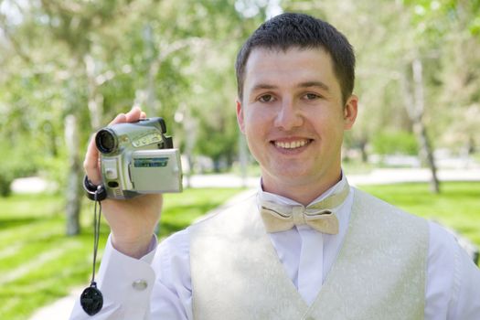 happy groom with videocamera