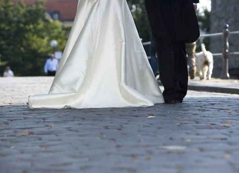 Married couple walking on a bridge from behind