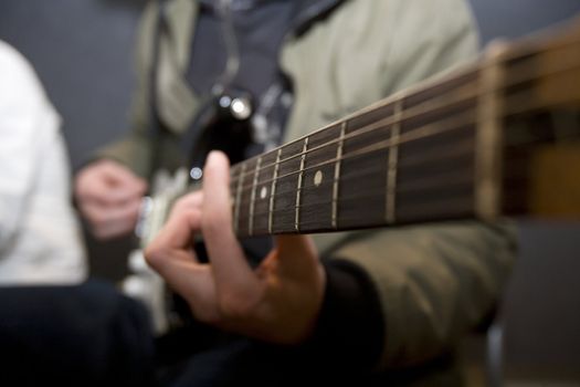 Unreconizable man playing the guitar