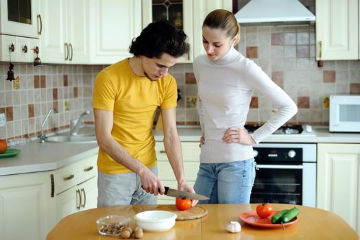 An image of couple in the kichen preparing vegetarian food