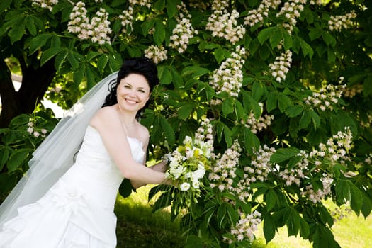 a happy bride near the tree