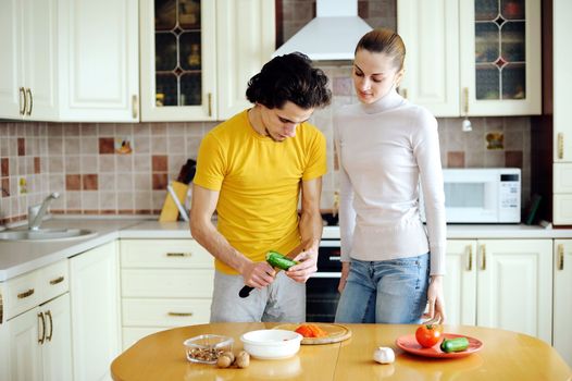 Young couple in the kichen preparing food