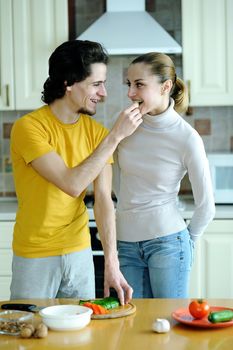 Young couple in the kichen preparing food