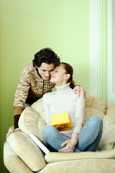 An image of couple in love, boyfriend is giving a present to his girlfriend