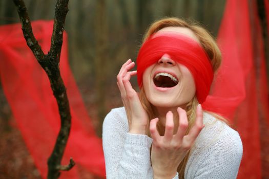 Screaming  blindfolded woman in the woods