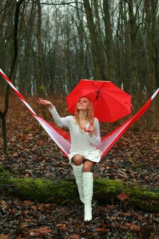 An image of a young woman with red umbrella