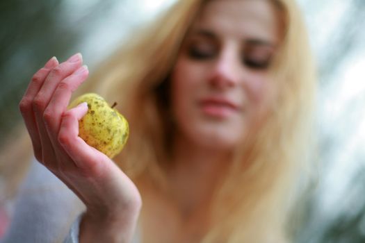 An image of woman with little yellow apple
