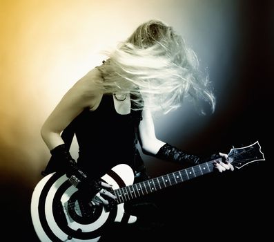 An image of a young woman with guitar