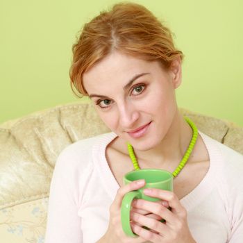 An image of a nice woman with green cup