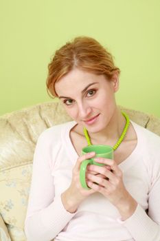 An image of a nice woman with green cup