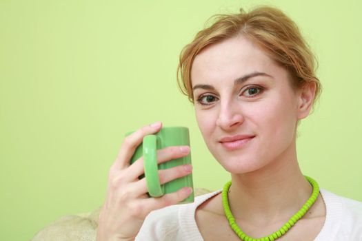 An image of a woman with green cup