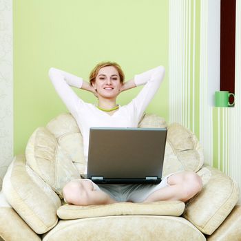 An image of a girl sitting in armchair