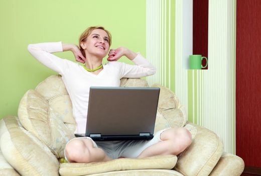 An image of nice girl with a laptop at home